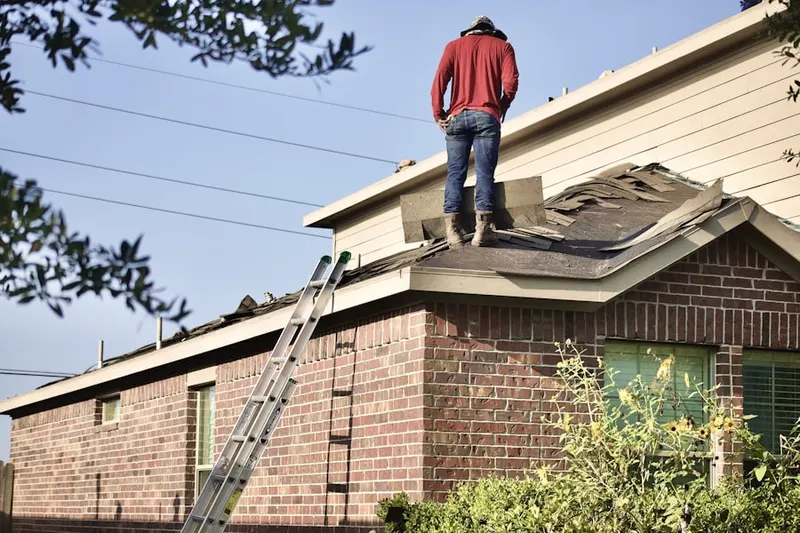 Professional roofer working on a residential roof in Timberview